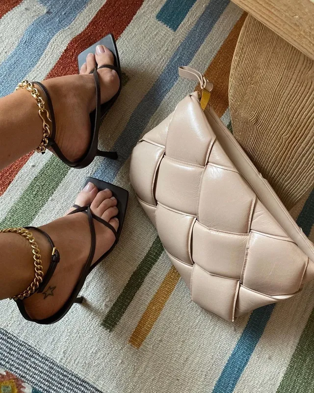Rosie Huntington-Whiteley black open-toe heels beside a quilted bag.