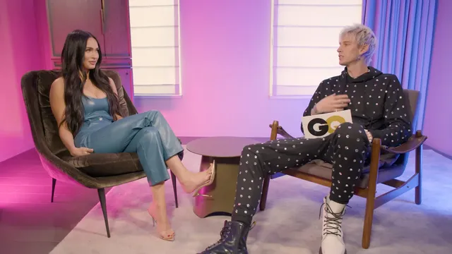 Megan Fox sitting in a television studio beside a host.