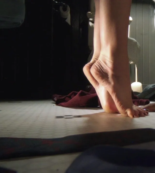 Lucy Hale a close-up of bare feet balanced on tiptoe.