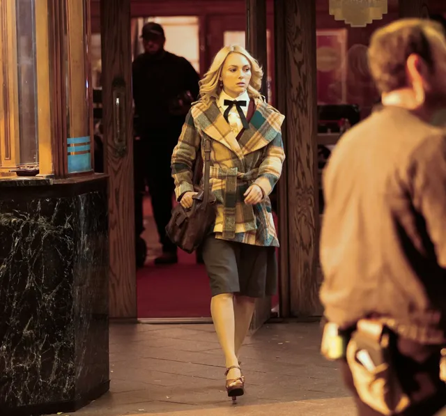 AnnaSophia Robb walking on a street during a screen production.