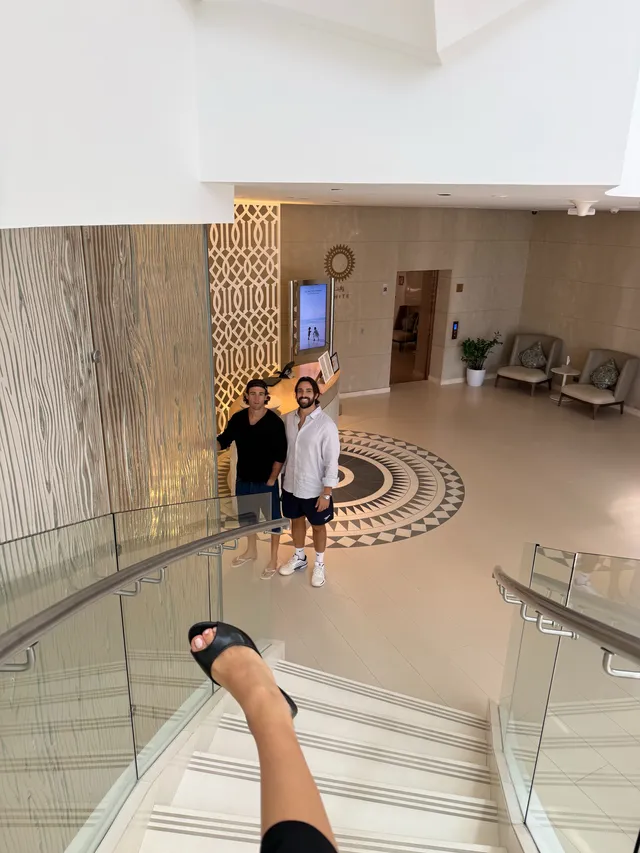 María Pedraza shown wearing a dark sandal while standing above a staircase.