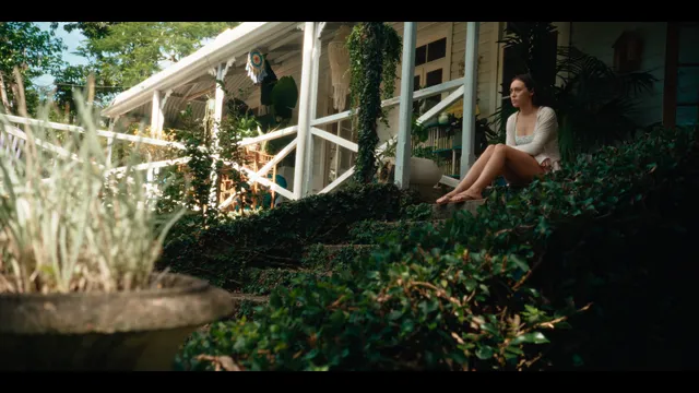 Alycia Debnam-Carey sitting outdoors during a screen scene.