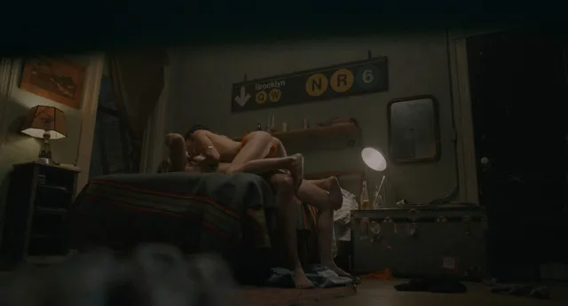Zoë Kravitz reclining in a dimly lit screen scene.