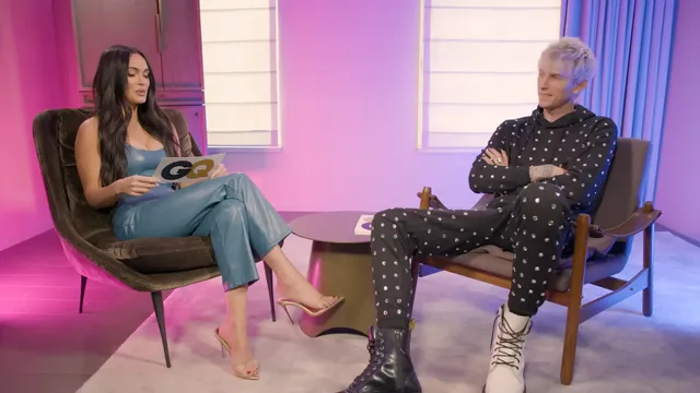 Megan Fox sitting opposite an interviewer in a studio.