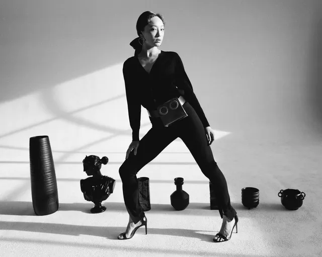 Havana Rose Liu posing in a black outfit and metallic heels.