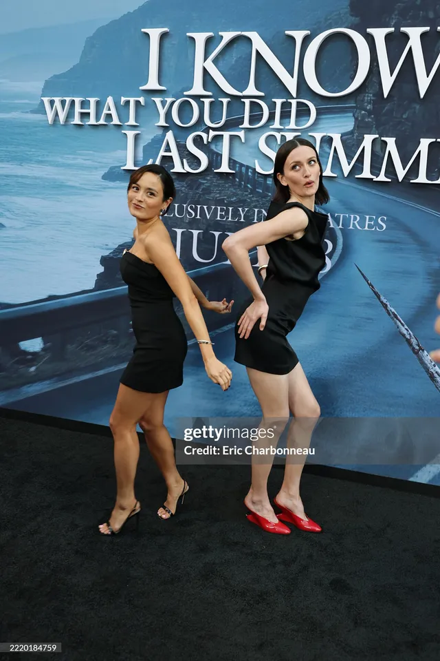 Chase Sui Wonders posing with a cast member in a black dress and heels.