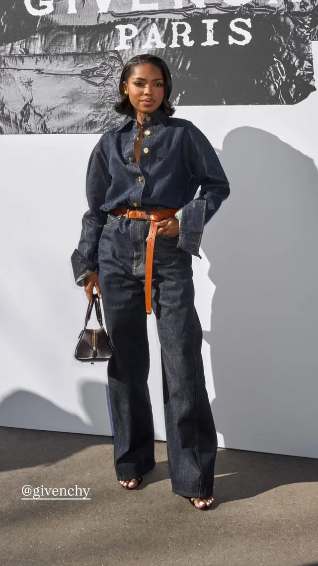 Ryan Destiny wearing a dark denim outfit and open-toe heels at a fashion event.