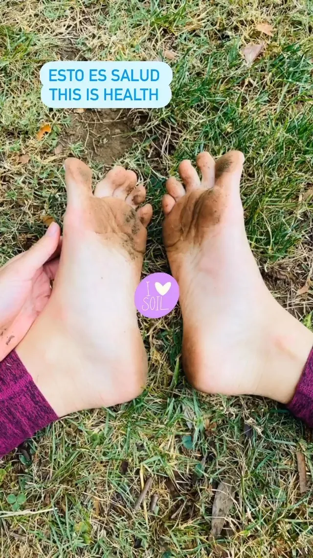 María Gabriela de Faría resting bare feet on grass.