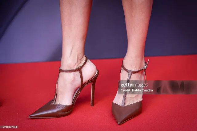 Eva Longoria wearing pointed metallic slingback pumps.