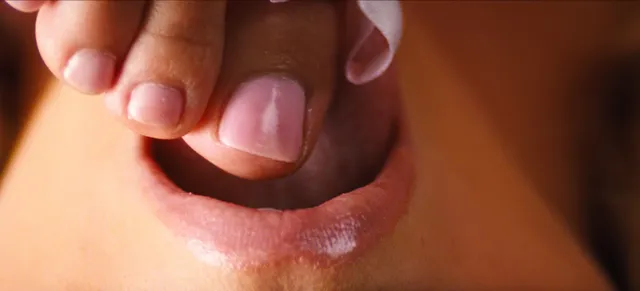 Sydney Sweeney: close view of painted toes beside her face.