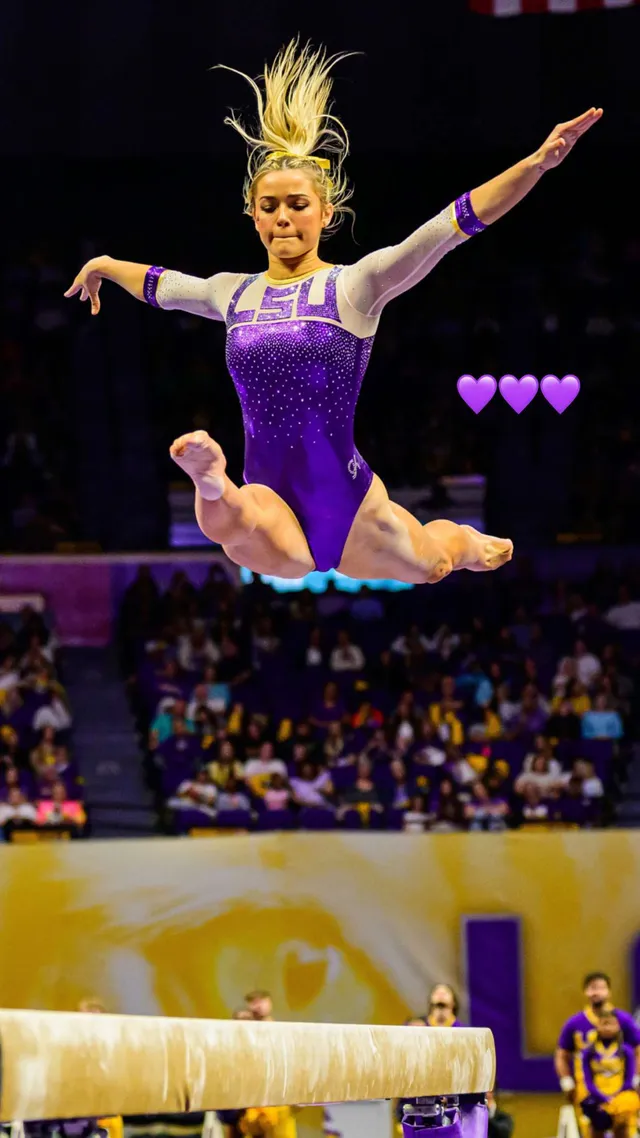 Olivia Dunne: performing a barefoot leap at a gymnastics competition.