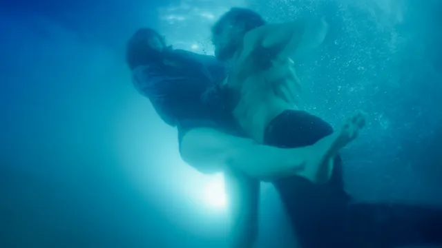 Odessa A'zion swimming underwater in a scene.