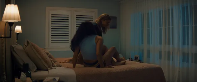 Chase Sui Wonders sitting on a bed in a scene.