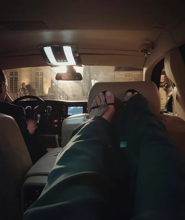 Elizabeth Gillies resting her feet in a vehicle.