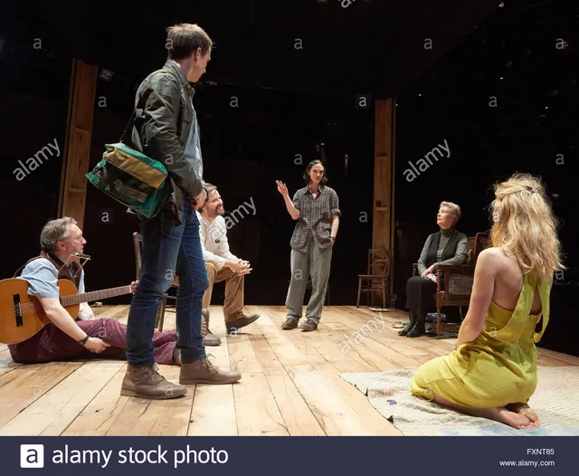 Vanessa Kirby seated barefoot on a theatre stage.