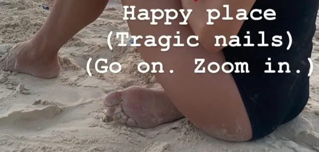 Yvonne Strahovski resting on a sandy beach.