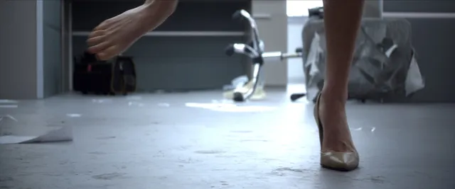 Samara Weaving stepping barefoot across a floor beside a discarded shoe.