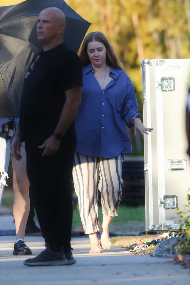 Amy Adams standing beside a companion in a casual outfit.
