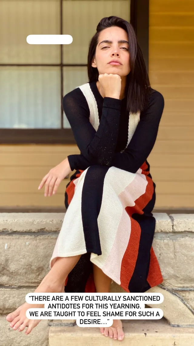 María Gabriela de Faría sitting barefoot in patterned trousers on a step.
