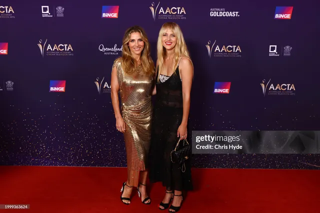 Teresa Palmer posing with a companion at an awards event.