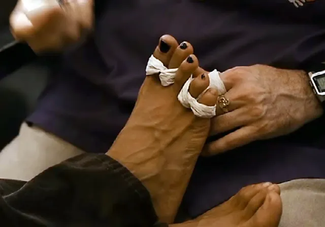 Rosario Dawson having her toes wrapped in a screen scene.