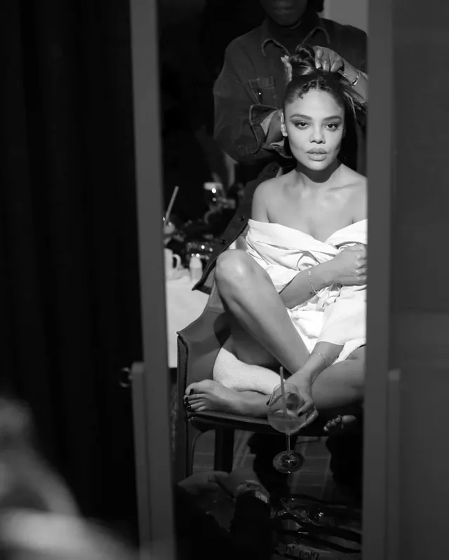 Tessa Thompson sitting in a monochrome backstage portrait.