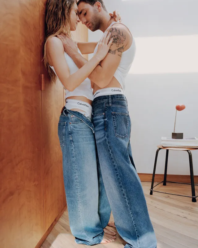 Grace Van Patten posing beside a man in jeans and a pale top.