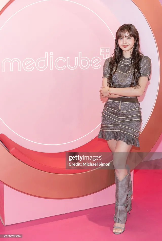 Lisa (Lalisa Manobal) wearing tall open-toe heels and a short patterned dress at a cosmetics event.