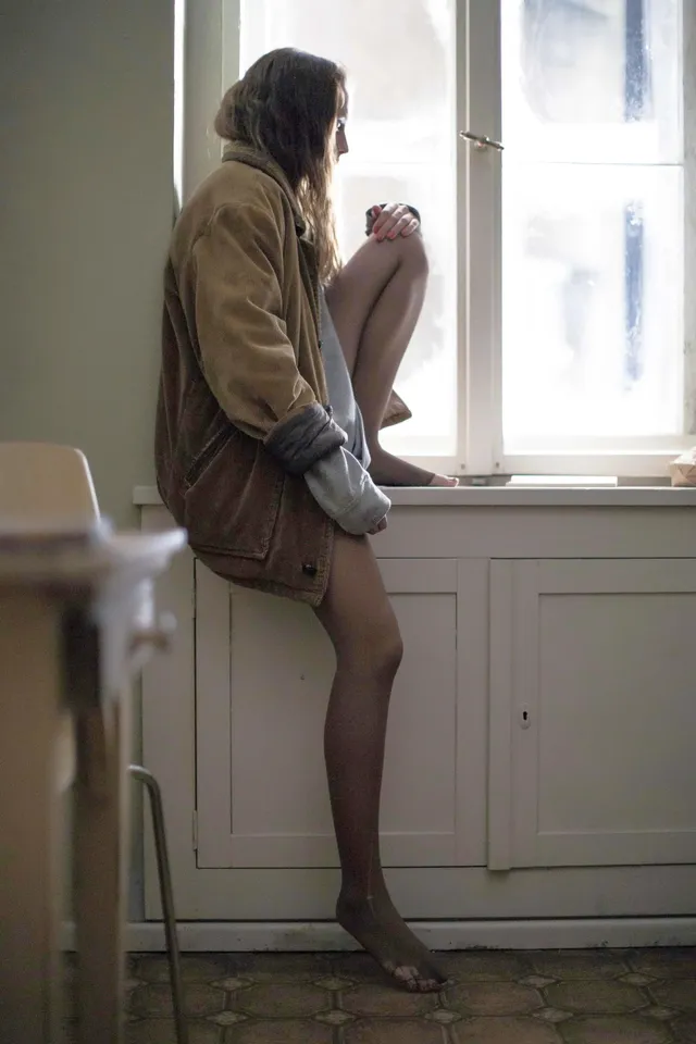 Teresa Palmer sitting beside a window during a portrait shoot.