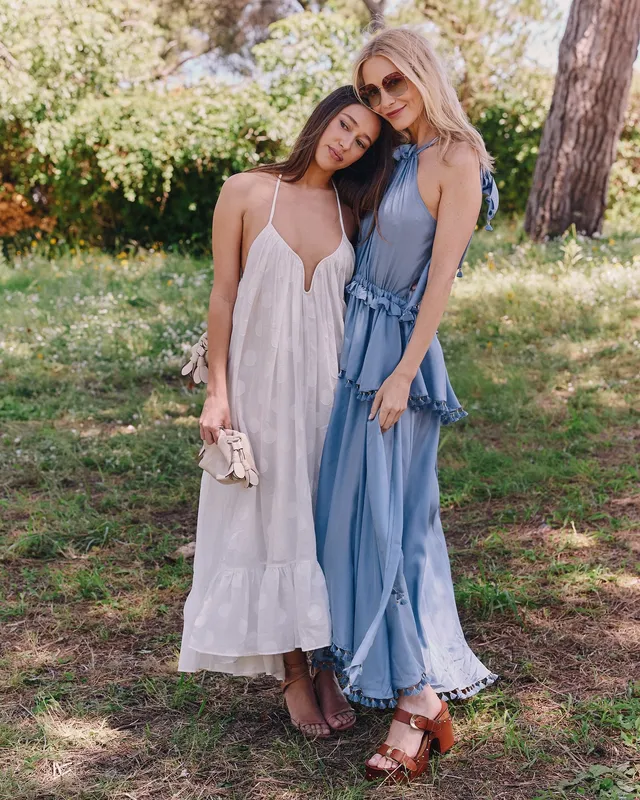 Alycia Debnam-Carey standing beside a companion in a white dress.