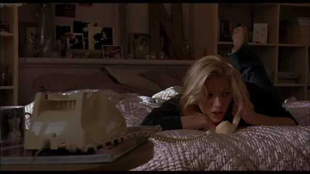 Scarlett Johansson lying on a bed in a film scene.
