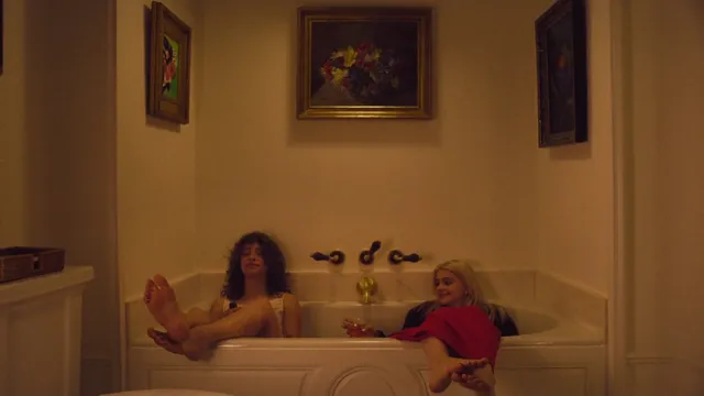 Ariel Winter sitting with a companion during a bath screen scene.