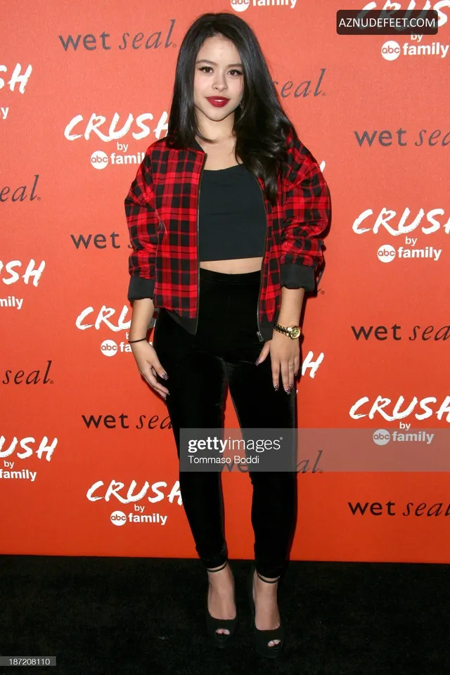 Cierra Ramirez in a red plaid shirt, black trousers and black heels at a clothing launch.