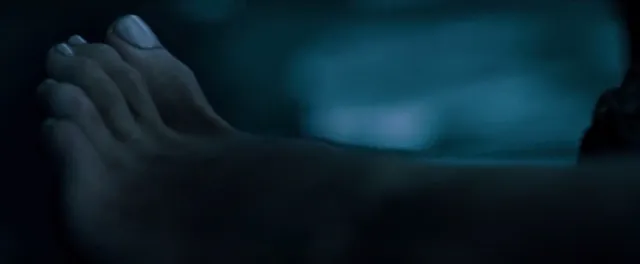 Blake Lively an underwater close-up in a dark screen scene.