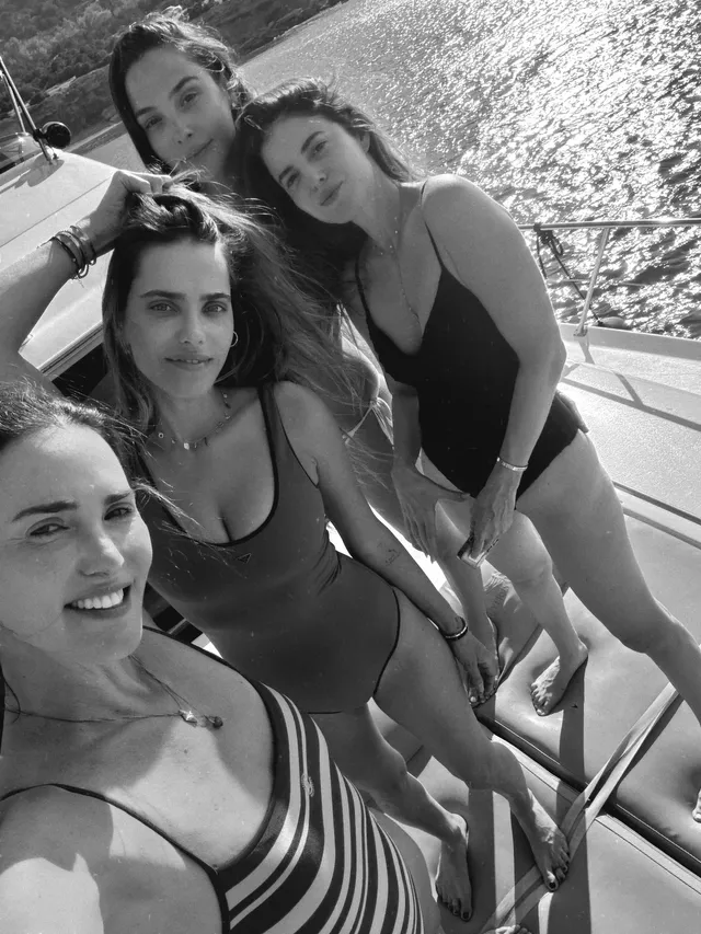 Gal Gadot standing barefoot on a boat with three women.