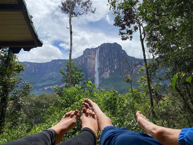 María Gabriela de Faría resting her bare feet outdoors with companions.