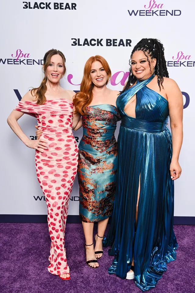 Isla Fisher posing with fellow actresses at a film event.