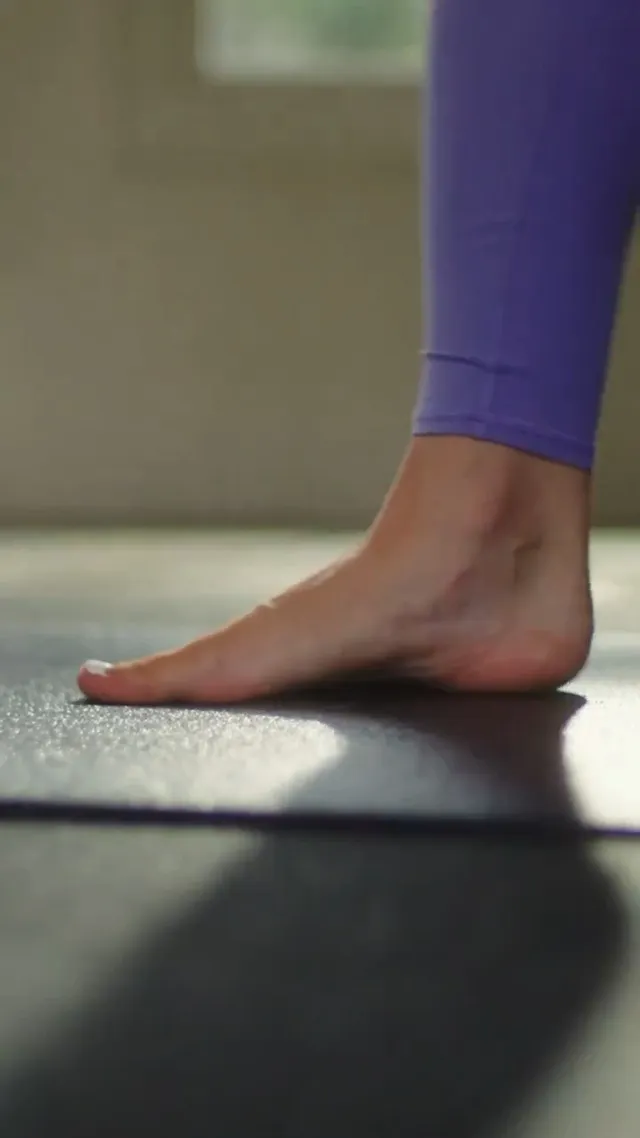 Olivia Dunne: close view of a bare foot on a gym floor.
