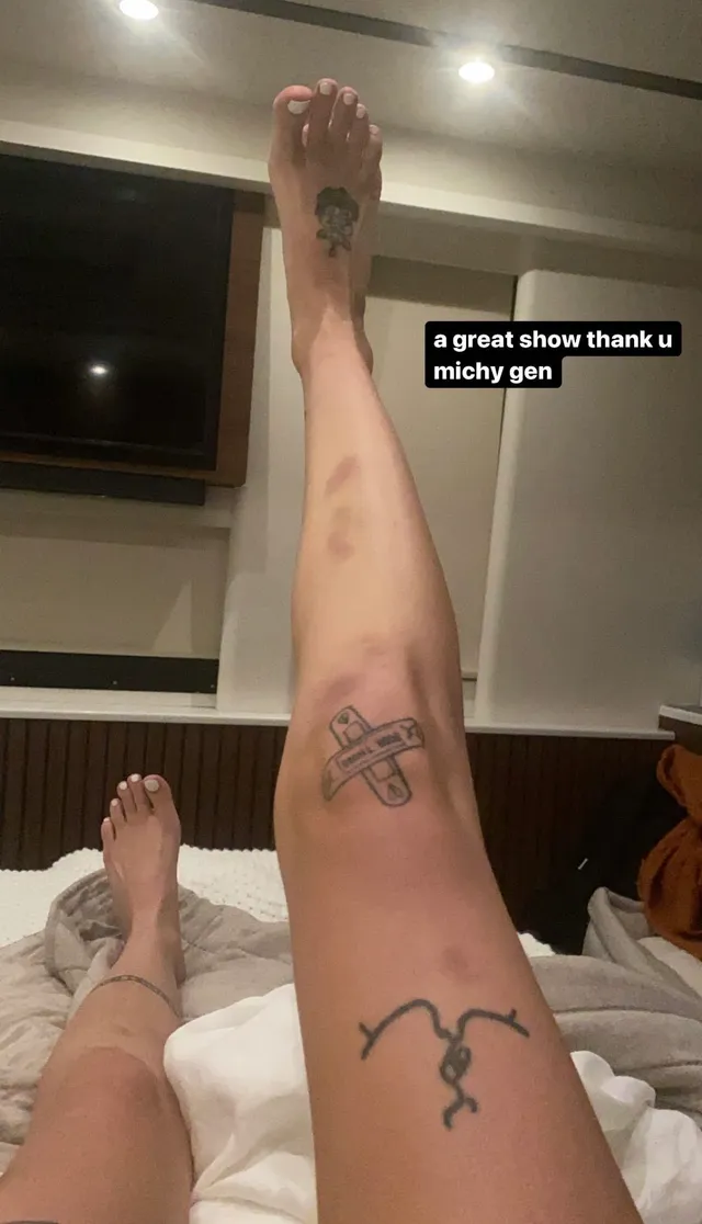 Halsey bare feet raised while relaxing on a bed.