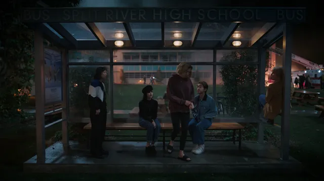 Peyton List standing barefoot outside in a screen scene.
