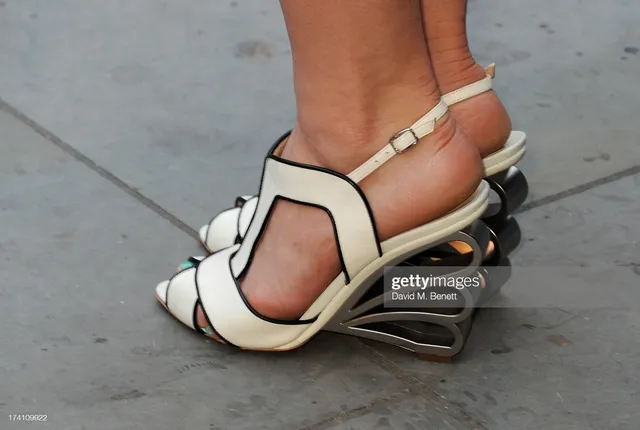 Natalie Dormer wearing sculptural white and black sandals.