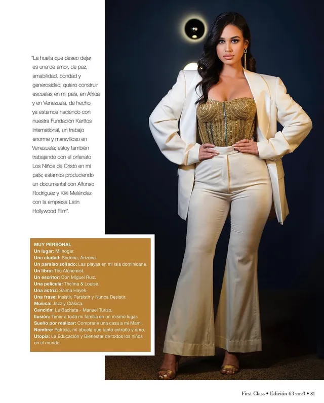Emily Tosta wearing a pale trouser suit and heels in a magazine photograph.