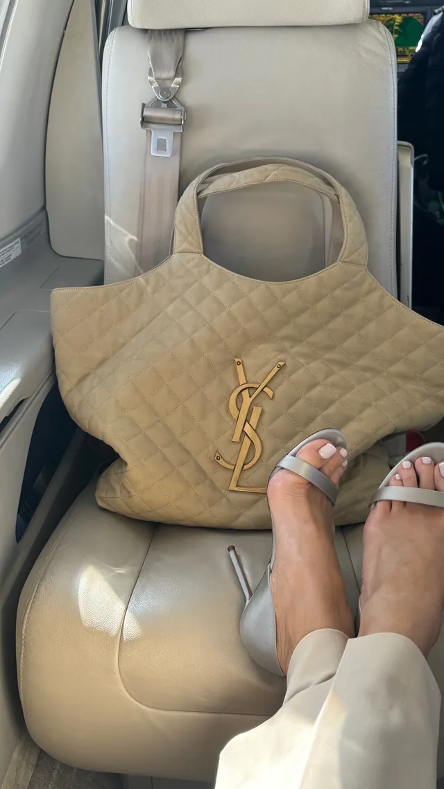 Rosie Huntington-Whiteley a pale pair of heels beside a handbag.