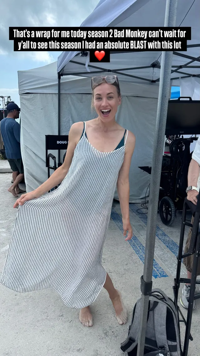 Yvonne Strahovski standing backstage in a pale dress.