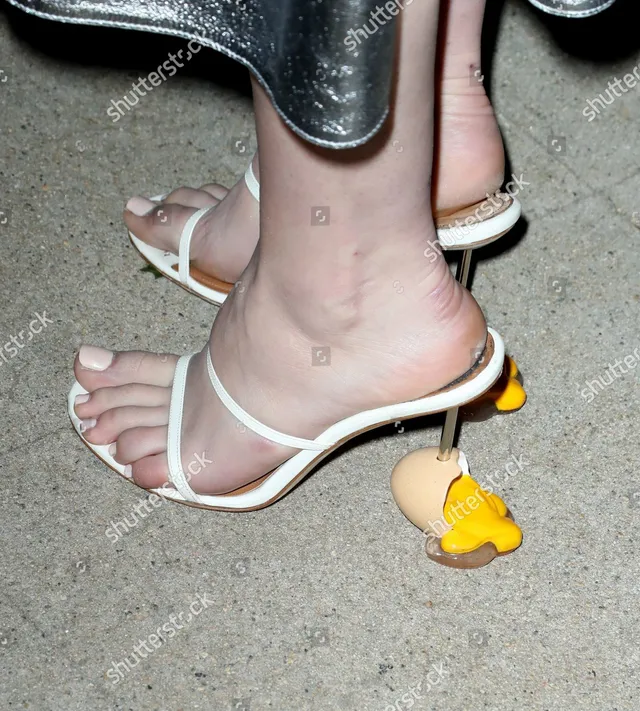 Daisy Edgar-Jones wearing pale heels decorated with a yellow detail.