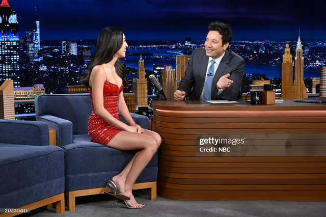 Olivia Rodrigo sitting beside a television host.