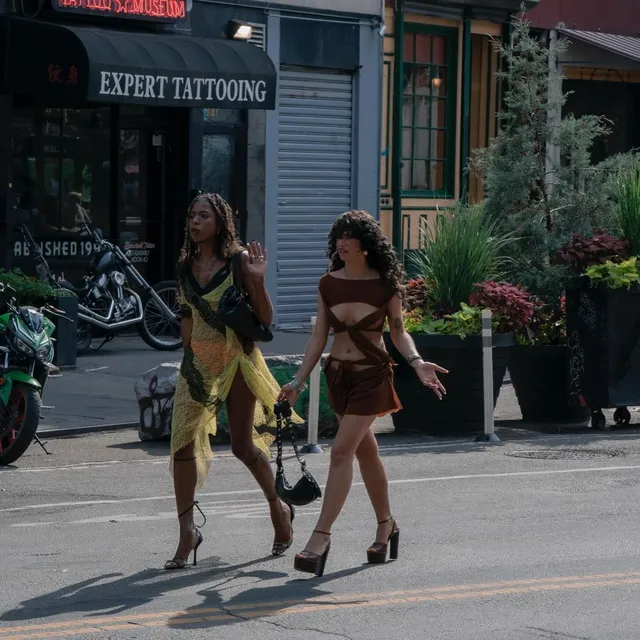 Odessa A'zion walking outdoors with a friend in platform heels.