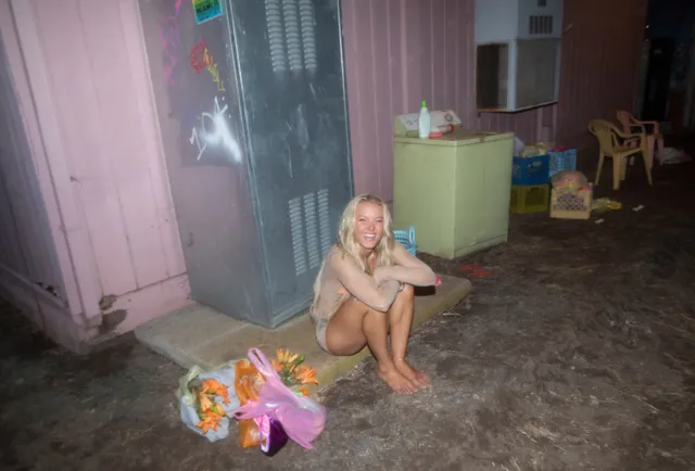 Zara Larsson crouching barefoot beside presents.