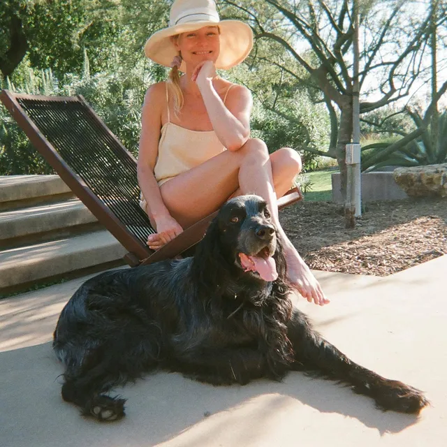 Kate Bosworth relaxing on a lounger beside a dog.