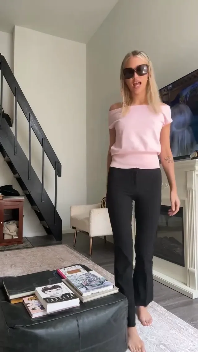 Grace VanderWaal standing barefoot indoors in dark trousers.